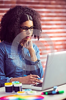 Casual businesswoman using her laptop