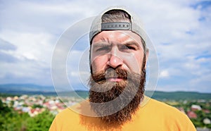 Casual chic. Cool hipster. Bearded man in fashion hipster cap outdoor. Brutal man with long beard and mustache. Hipster photo