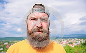 Casual chic. Cool hipster. Bearded man in fashion hipster cap outdoor. Brutal man with long beard and mustache. Hipster photo