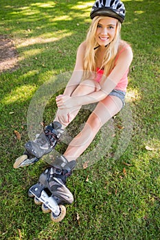 Casual content blonde wearing roller blades and helmet