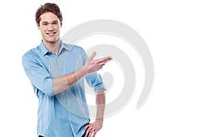 Casual cool guy pointing away