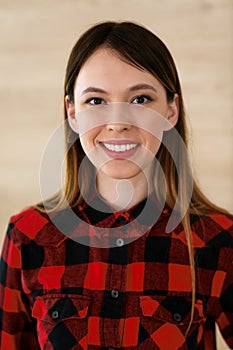 Casual dressed business woman headshot in home office. Young asian entrepreneur or student girl standing and smiling at photo