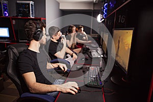 Casual gamers gather together in pc gaming club to compete in online tournament