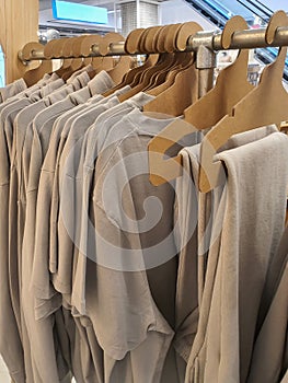 Casual gender neutral clothes on a rack in a store