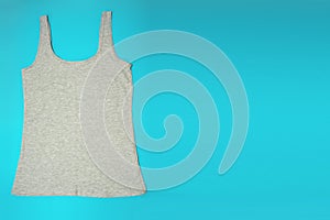 Gray sleeveless female casual tank top on blue background. Copyspace. Sport, fitness aparrel. Basic look photo