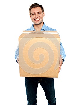 Casual guy carrying packed cardboard boxes