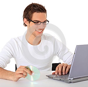 Casual guy installing software on his laptop