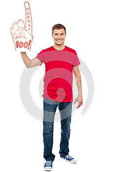 Casual guy showing large pointy boo hurray hand