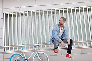 Casual guy with a vintage blue and white bike