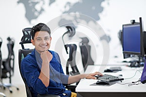 Casual indian business man working on desktop computer