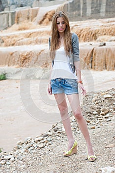 Casual lady, a river after strong rain as background
