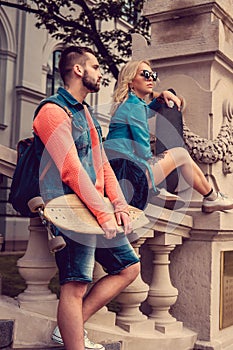 Casual longboarders posing in a town.