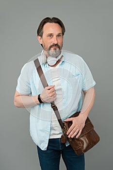 Casual looks gorgeous on him. Bearded man listen to music in casual style. Mature man wear casual clothing grey