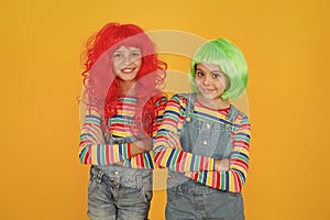 Casual but luxury. Casual party look of little children. Small girls wear colored hair wigs in casual denim style. Happy