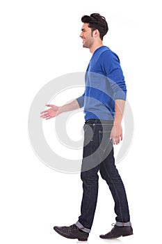 Casual man in blue jeans and shirt walking