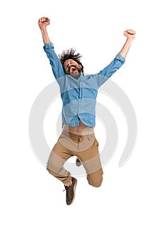 Casual man full of excitement is jumping in the air