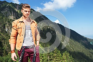 Casual man with hand in pocket in the mountains