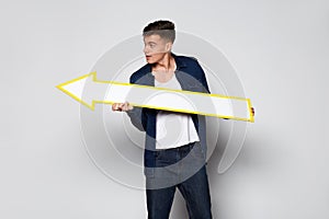 Casual Man holding white arrow on white background