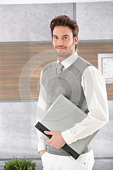 Casual man with laptop smiling