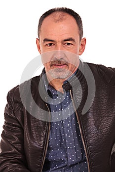 Casual man in leater jacket posing in studio photo