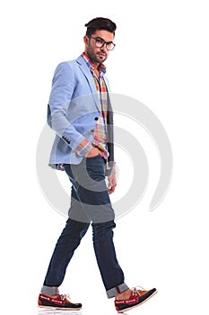 Casual man looking at the camera while walking