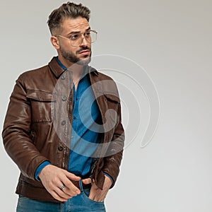 Casual man looking to side with one hand in pocket