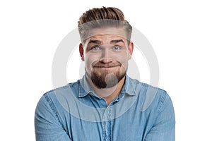 Casual man making a funny face while having a difficulty