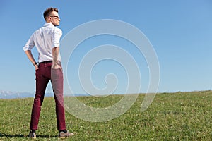 Casual man outdoors with his back at you