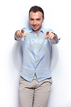 Casual man pointing with both hands at you