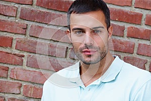 Casual, man and portrait with brick wall in confidence outside with face for closeup city. Smile, pride and informal in