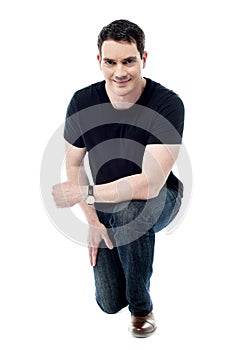 Casual man posing crouched