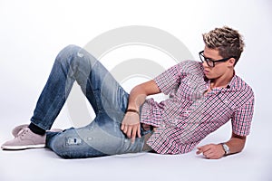 Casual man relaxes on floor