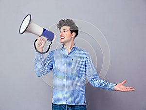 Casual man screaming on megaphone