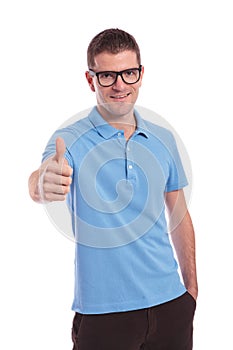 Casual man shows thumb up