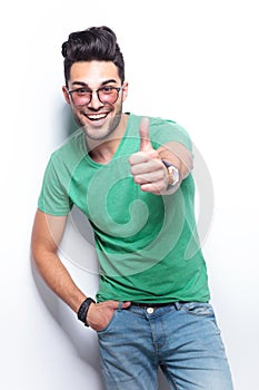 Casual man shows the thumbs up sign