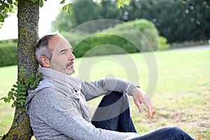 Casual man sitting in garden photo