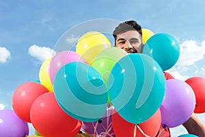 Casual man surrounded by baloons