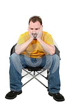 Casual Man Upset Sitting In Chair Over White