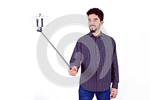 Casual man using a selfie stick