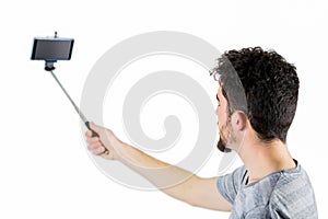 Casual man using a selfie stick