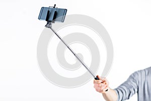 Casual man using a selfie stick