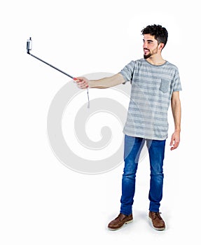 Casual man using a selfie stick