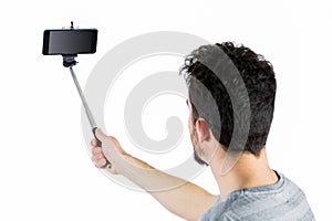 Casual man using a selfie stick