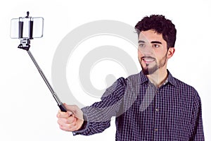 Casual man using a selfie stick