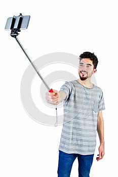 Casual man using a selfie stick
