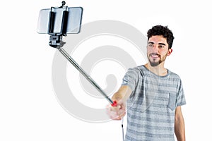 Casual man using a selfie stick
