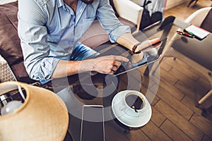 Casual Man Using Tablet Computer Sitting in Cafe Surfing Internet