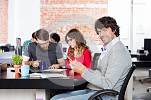 Casual man using tablet sitting working office desk, business people