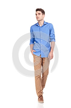 Casual man walking with his hand in pocket on