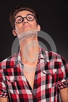Casual man wearing glasses looking up